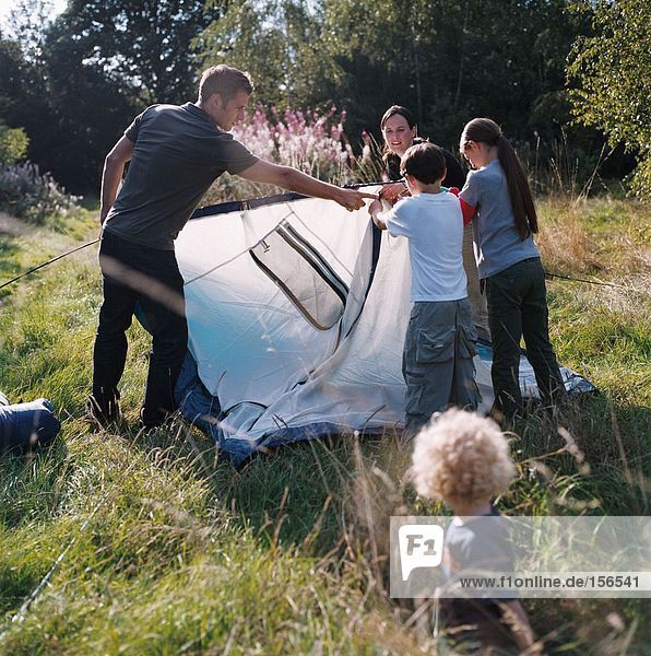 Family erecting a tent