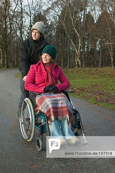 Disabled woman and partner in park
