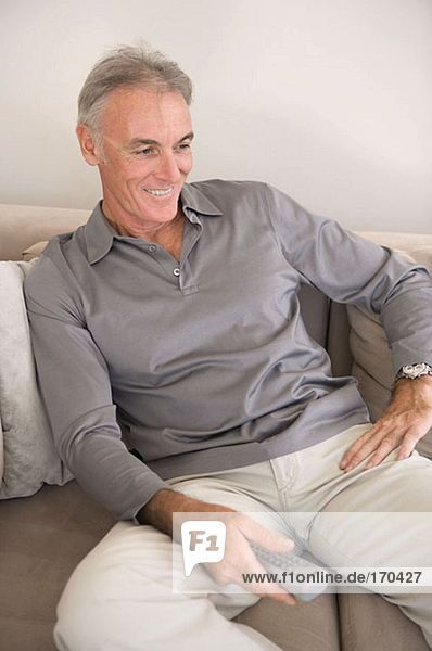 Mature man with remote control
