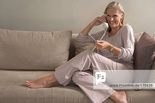Woman on phone holding credit card