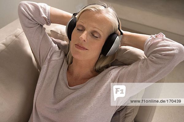 Mature woman wearing headphones