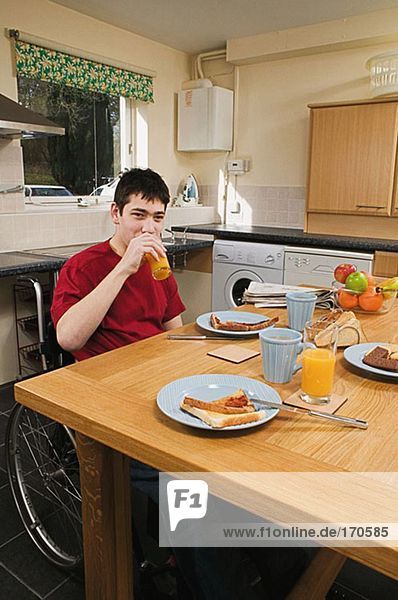 Disabled man having breakfast