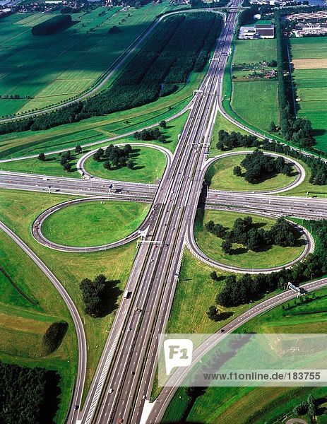 Aerial view of clover leaf-shaped highway overpasses