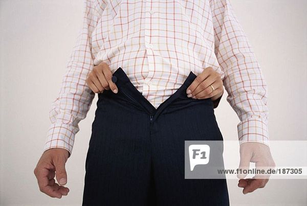 Woman undoing man's trousers