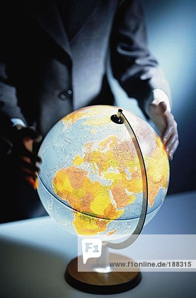 Businessman touching a globe