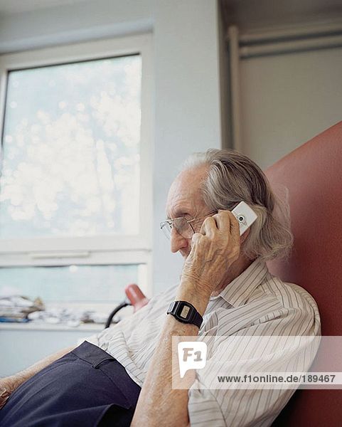 Elderly man using mobile phone
