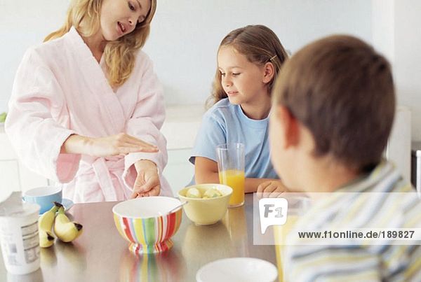 Mother and children having breakfast