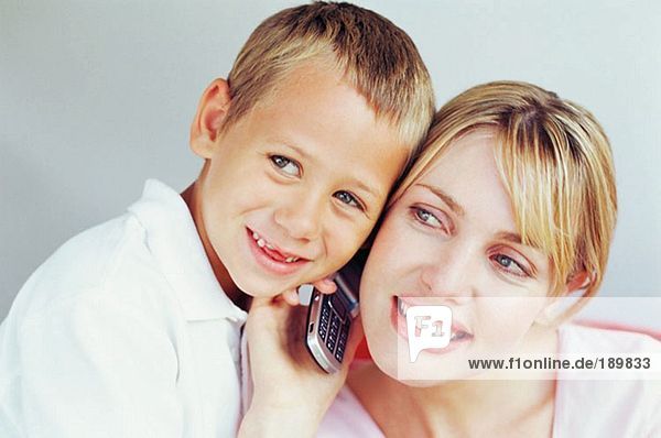Mother and son using mobile phone