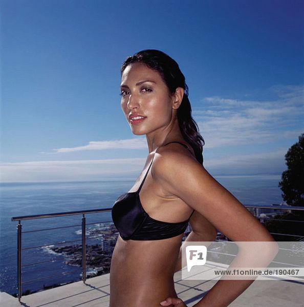 Woman in a bikini on a balcony