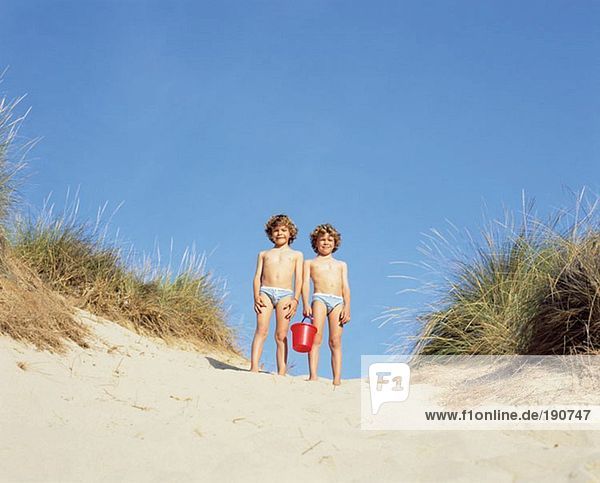 Twin boys in a sand dune