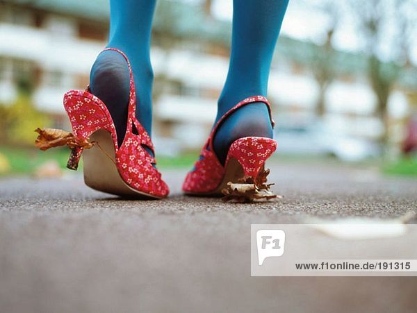 Woman with leaves stuck to her shoes