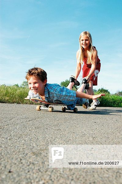 Boy und Girl playing with skateboard