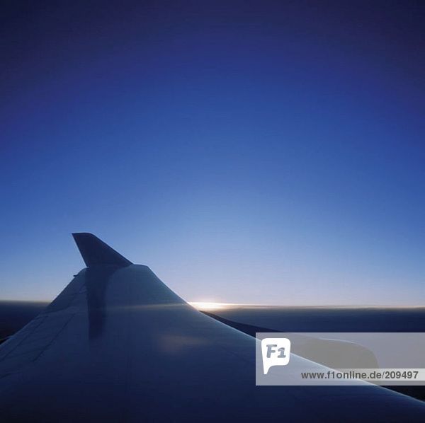 Aeroplane wing at sunrise