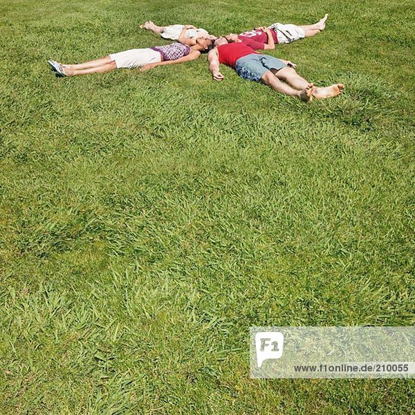Friends lying on the grass