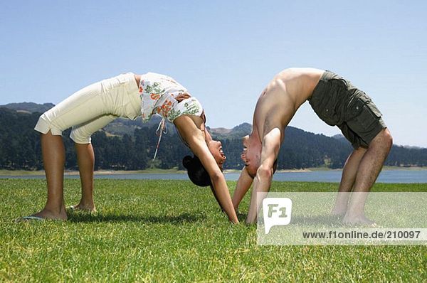 Man and woman bending over backwards