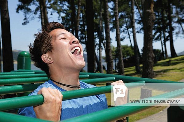 Young man on monkey bars