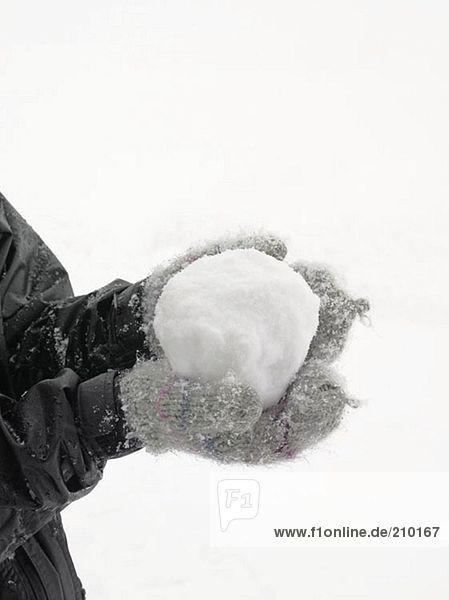 Person holding a snowball