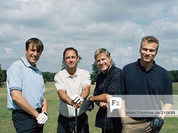 Rear view of four golfers