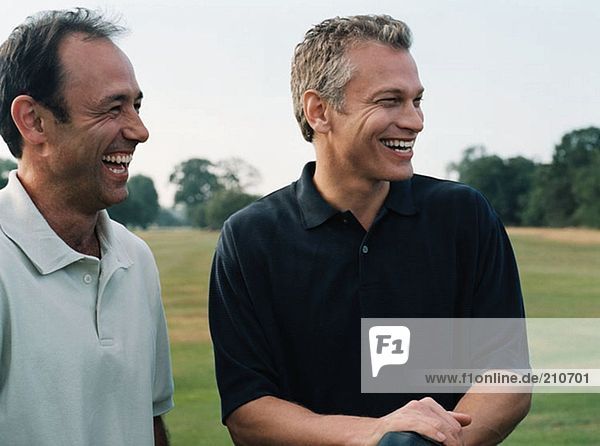 Two golfers laughing