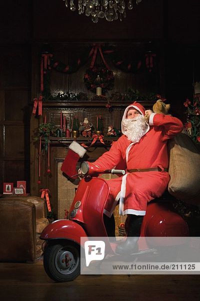 Santa claus riding a moped