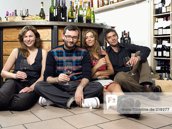Group of friends on floor at wine tasting