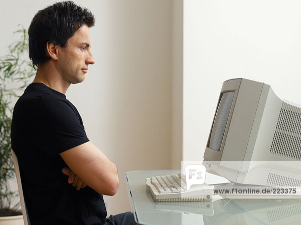 Mann schaut auf den Computerbildschirm