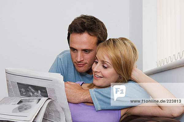 Couple reading a newspaper