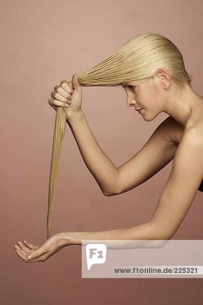Side profile of young woman washing her hair