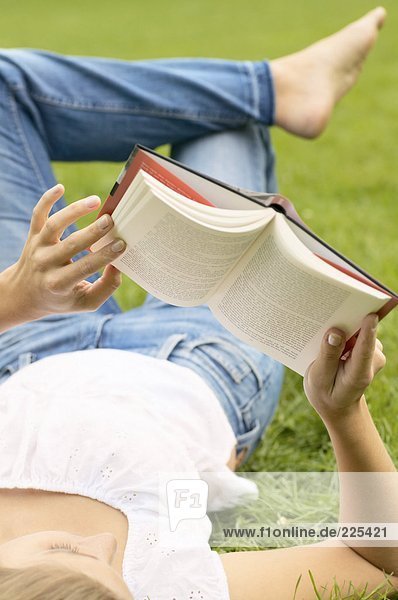 Woman reading book in lawn
