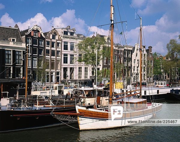 Boats moored at harbor  Amstel River  Amsterdam  Netherlands