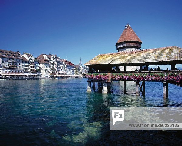 Covered bridge across lake  Chapel Bridge  Vierwaldstaetter Lake  Switzerland