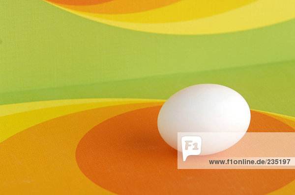 Easter egg against coloured background  close-up