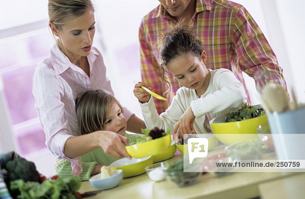 Family in kitchen preparing salad  children (4-7)