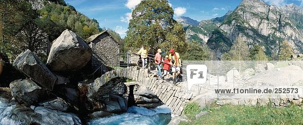 10481747  parents  family  river  flow  children  Switzerland  Europe  stone bridge  Ticino  Val Calneggia  walking  hiking