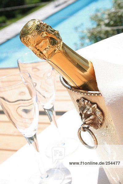 Close-up of Champagne bottle in ice bucket
