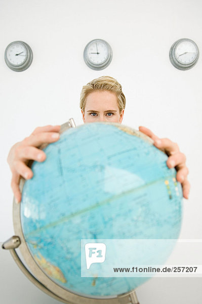 Businesswoman holding a globe