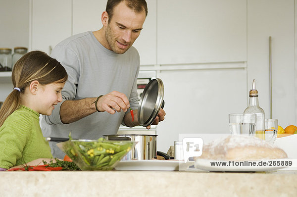 Man and girl in kitchen