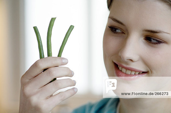 Woman with 3 green beans