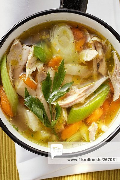 Chicken soup with vegetables in saucepan