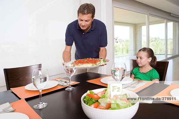Father bringing meal to table