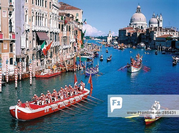 Boatmen rowing boats in canal  Grand Canal  Santa Maria Della Salute  Venice  Italy
