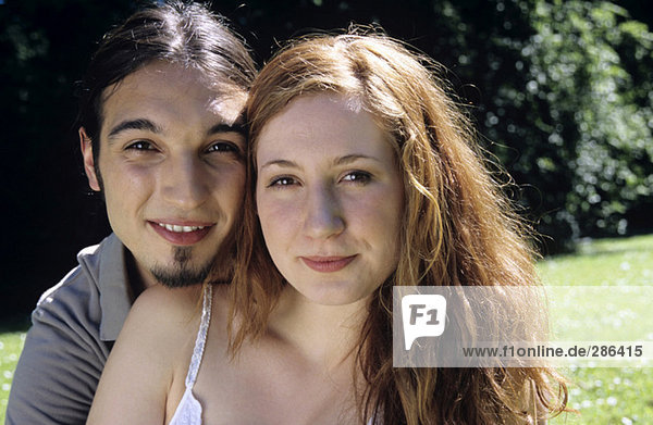 Young man embracing young woman  portrait  close-up