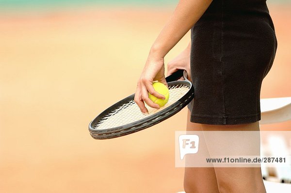 Nahaufnahme der weiblichen Spieler hält Tennisball