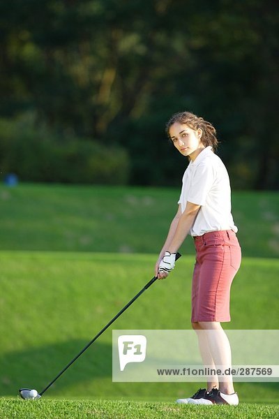A young woman contemplates before playing a shot