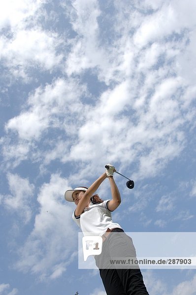 High angle view of a man playing a golf stroke