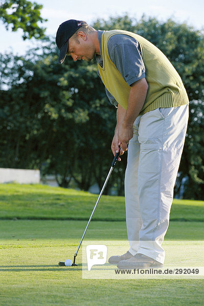 A man playing golf.