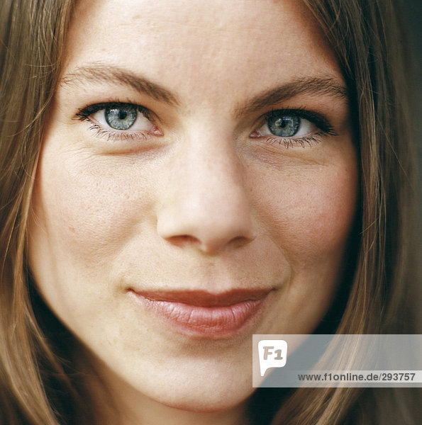 Close-up of a smiling woman's face.