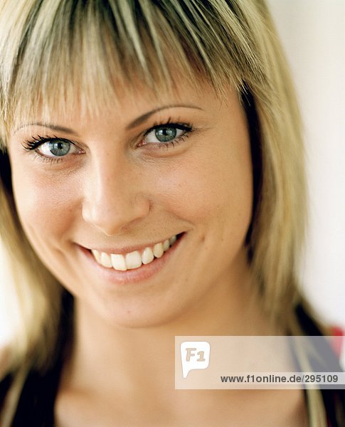 A smiling woman looking at the camera portrait.
