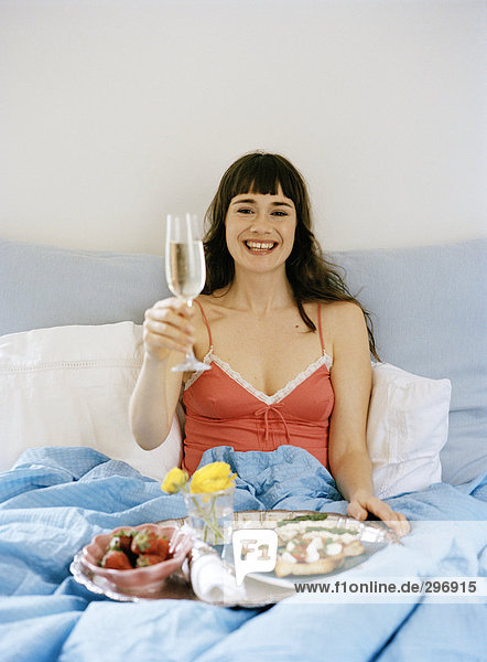 A woman with breakfast in bed.