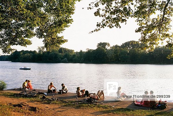 People relaxing on pier at riverside  Hannover  Lower Saxony  Germany